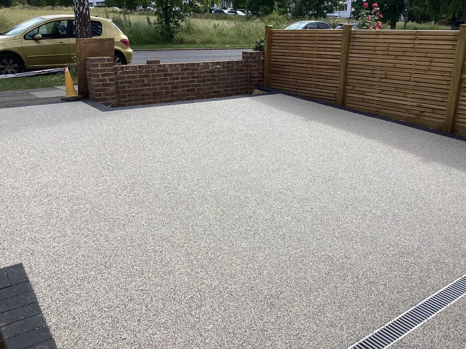 Resin-bound driveway finished alongside a new brick wall and close-board fencing