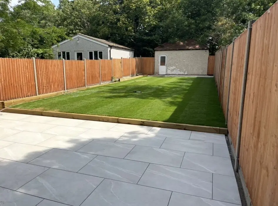 New turf, paving and fencing combined in a long rear garden