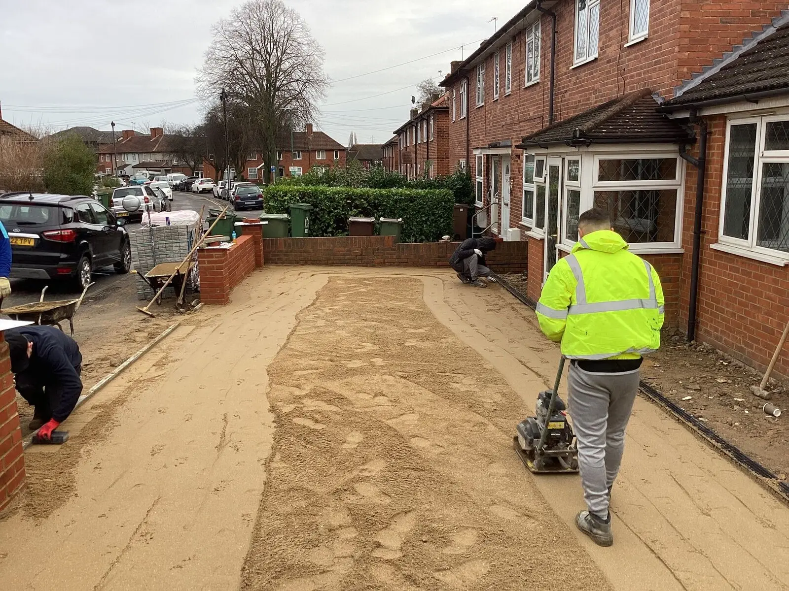 Groundwork in progress — the sub-base being compacted before a new driveway is laid